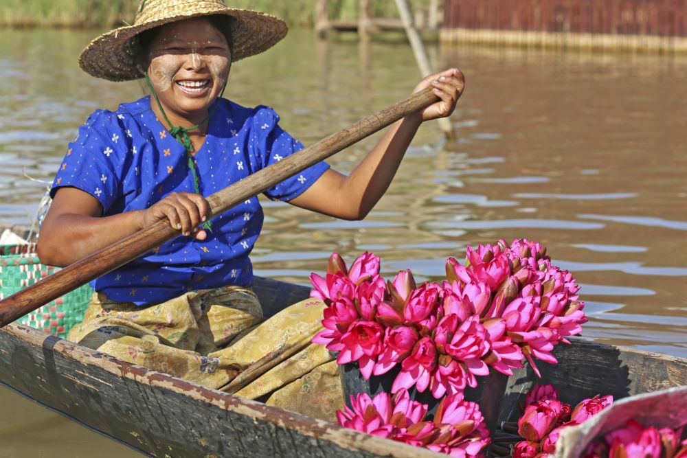 Marktfrau auf dem Inle-See mit Lotosblumen