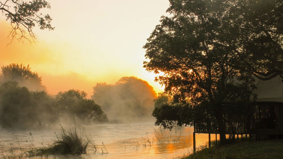 Mystischer Sonnenaufgang mit Nebel über dem Fluss