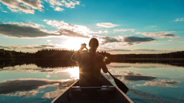 girl canoeing at kinasao beautiful water reflection clouds sunset