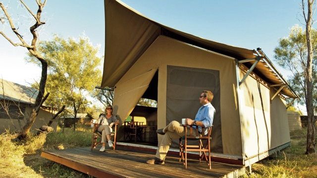 APT Wilderness Lodge Bungle Bungles couple on veranda tent bungalow
