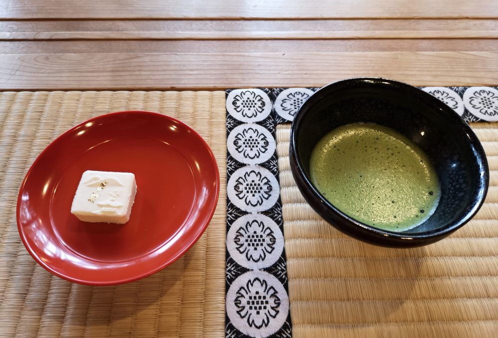 Ästhetisch angerichteter Tee und japanische Süßigkeit während einer Teezeremonie