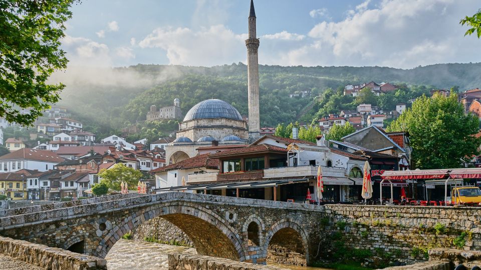 Die alte Steinbrücke überspannt die Bistrica. Im Hintergrund die Sinan-Pascha-Moschee und links auf dem Berg die Festung von Prizren.