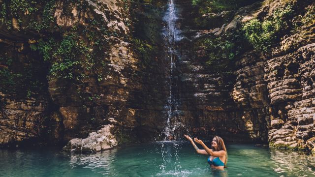Frau genießt die versteckten Wasserfällen im Nivica Canyon